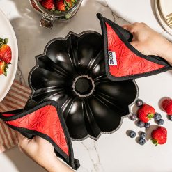 Alternative view of Lodge Heritage Cast Iron Fluted Cake Pan with Red Potholders